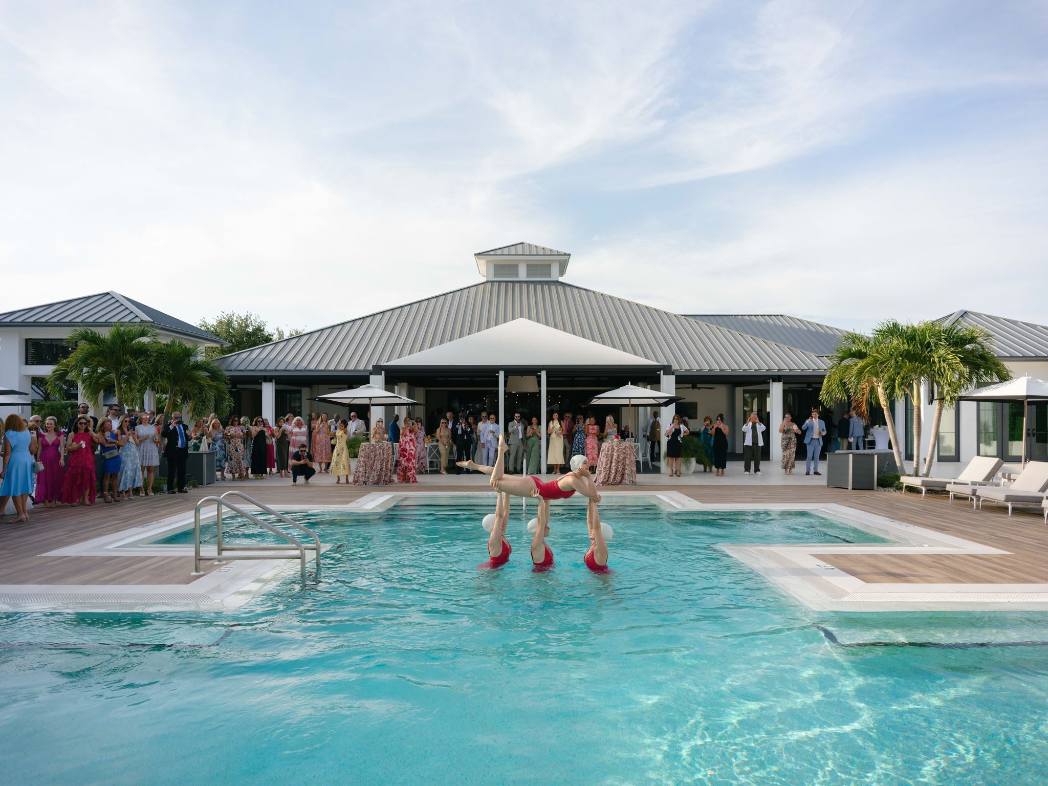 Featured synchronized swimming performance with luxury wedding audience